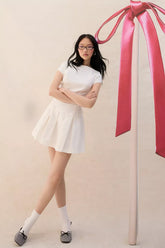 UO Bryan Bow-Back Pleated Drop Waist Denim Mini Dress